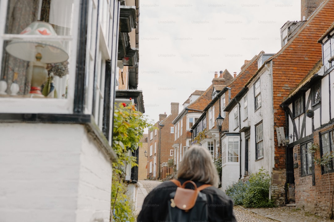 Person walking down a charming cobblestone street in a Lake District town