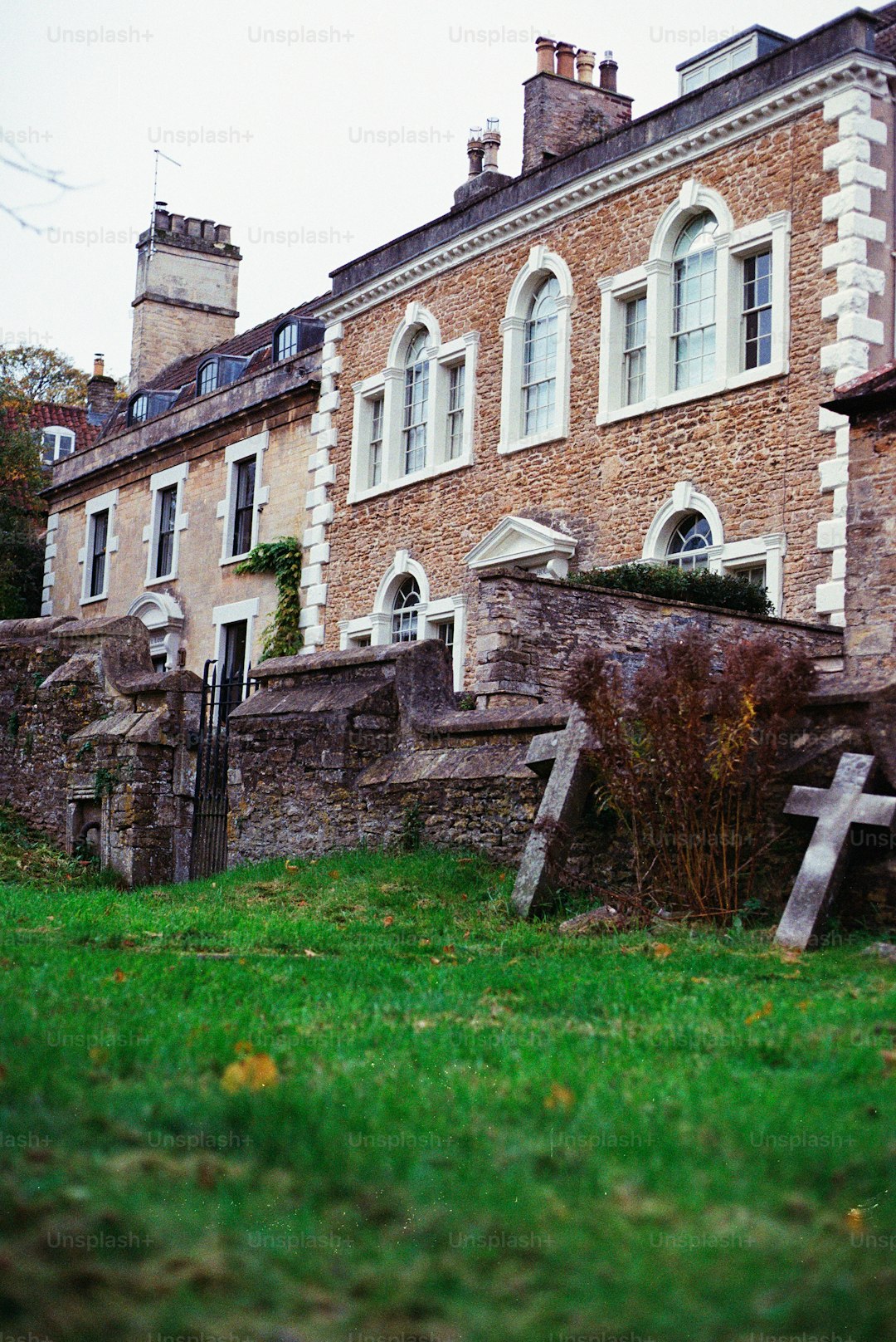 Old stone buildings with a grassy courtyard, similar to Appleby Castle